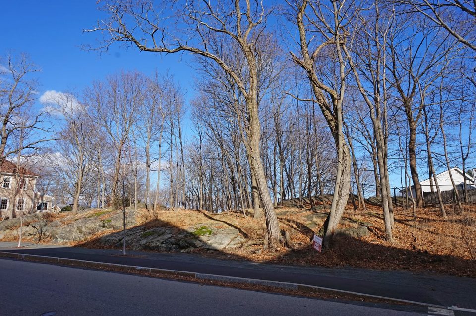 Proctor's Ledge, as seen from Proctor Street on top of the hill. A small memorial has been built below the ledge on Pope Street.