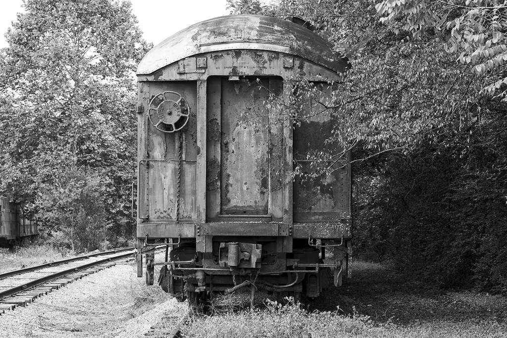 Black and white photograph of a rusty abandoned train car by Keith Dotson