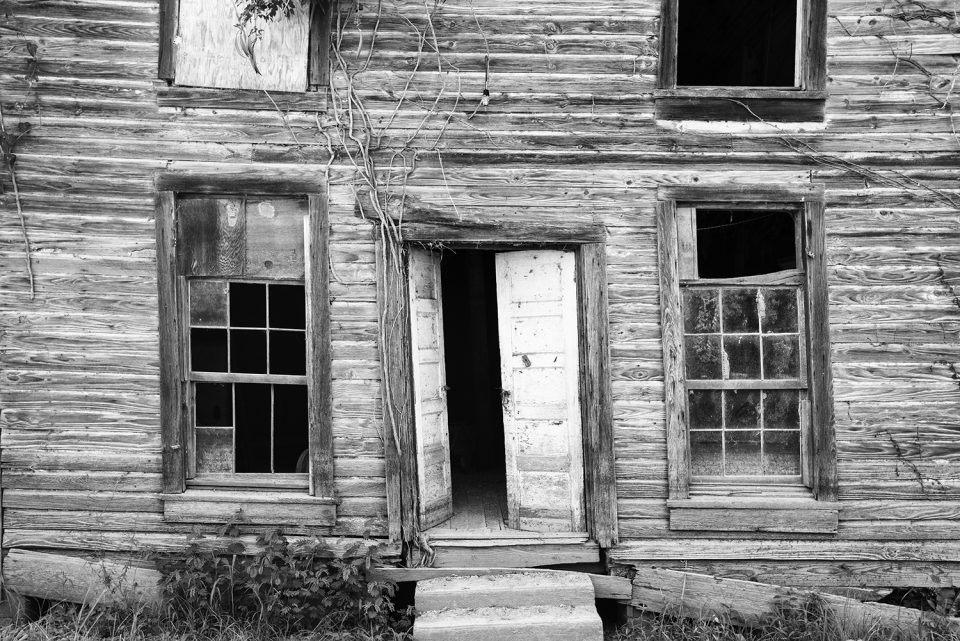 Black and white photograph of an abandoned building in Rodney, Mississippi. This building may have been a saloon, or a house, or a Masonic Lodge (or all three).