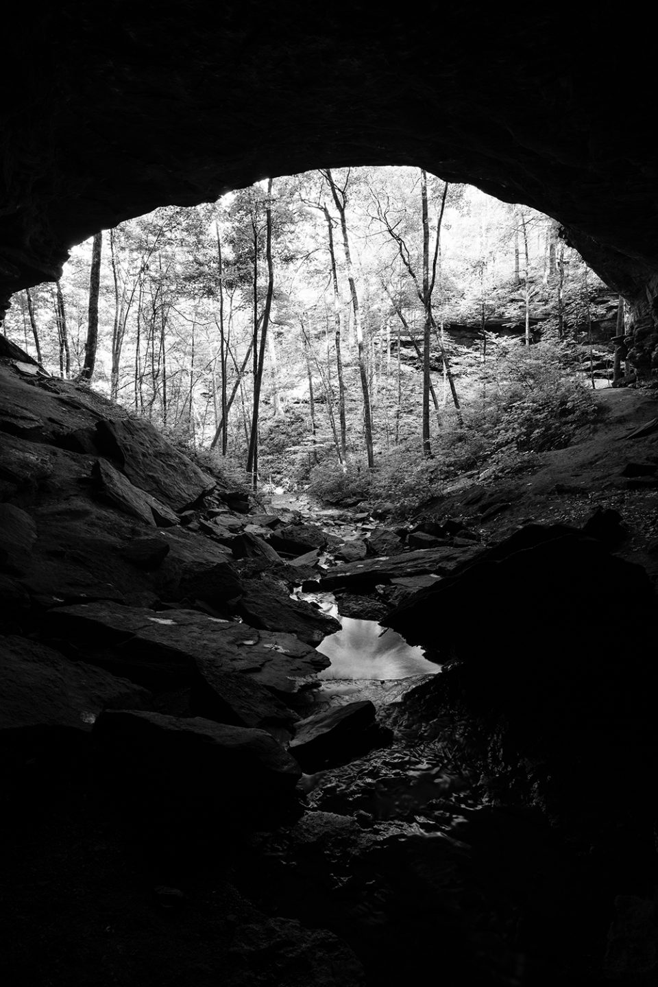 The stream running toward the mouth of the cave, black and white photograph by Keith Dotson.