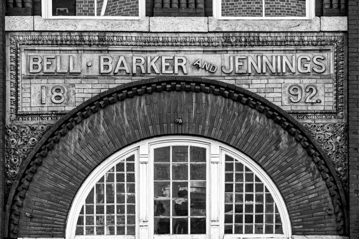 Old Sign for Bell, Barker, and Jennings (1892) on the front of an office building in Lynchburg Virginia.