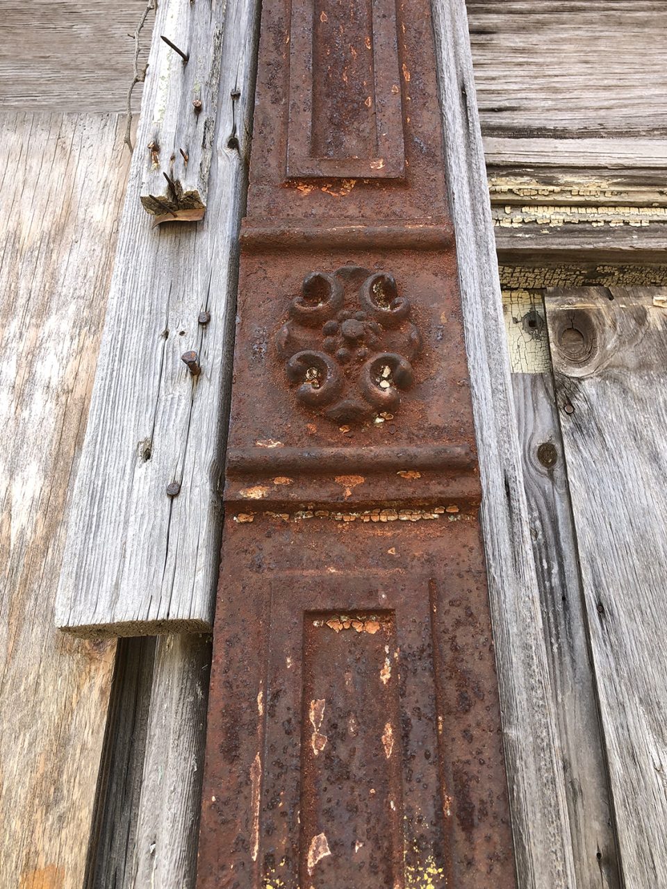 Top of the rusty iron column manufactured by Chickasaw Iron Works Memphis, Tennessee. Seen in Clarksdale, Mississippi.