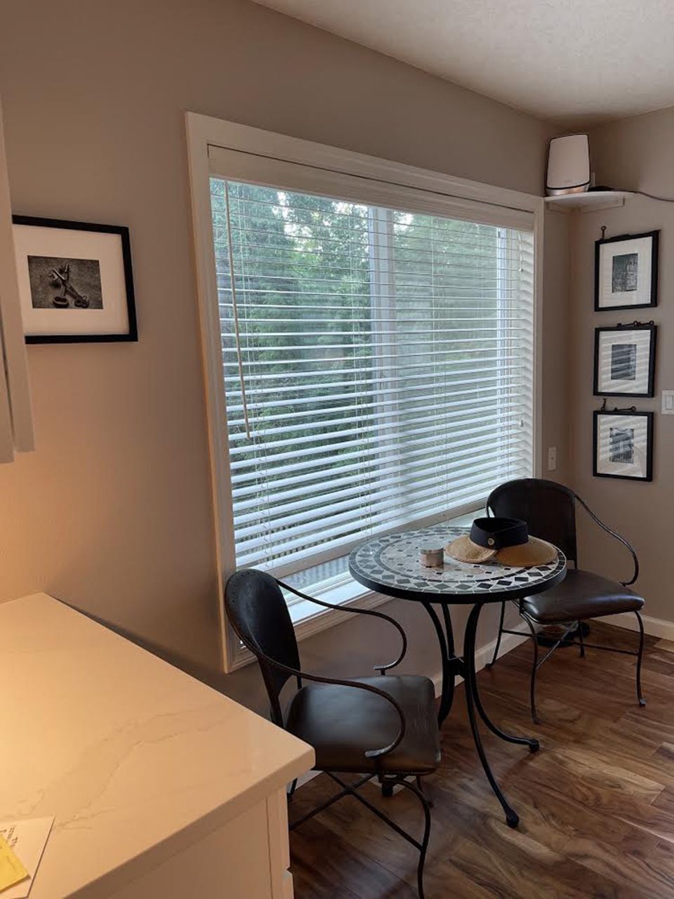 This view of the breakfast nook shows three Keith Dotson photographs along the right wall and another on the far left.