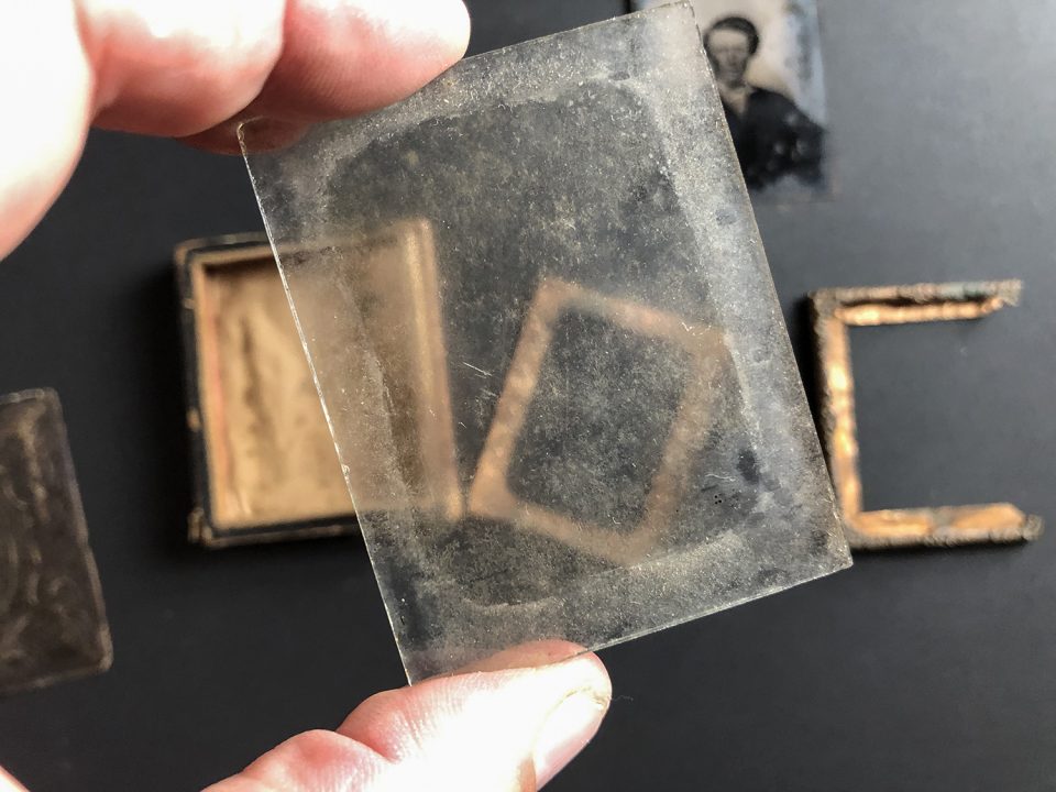 A century-and-a-half of dirt and grime on the glass of the old tintype frame