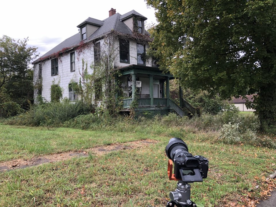This photograph shows my trusty camera before one of the many long-abandoned homes in this neighborhood in Cairo, Illinois. Slowly but surely, it's being consumed by the forest.