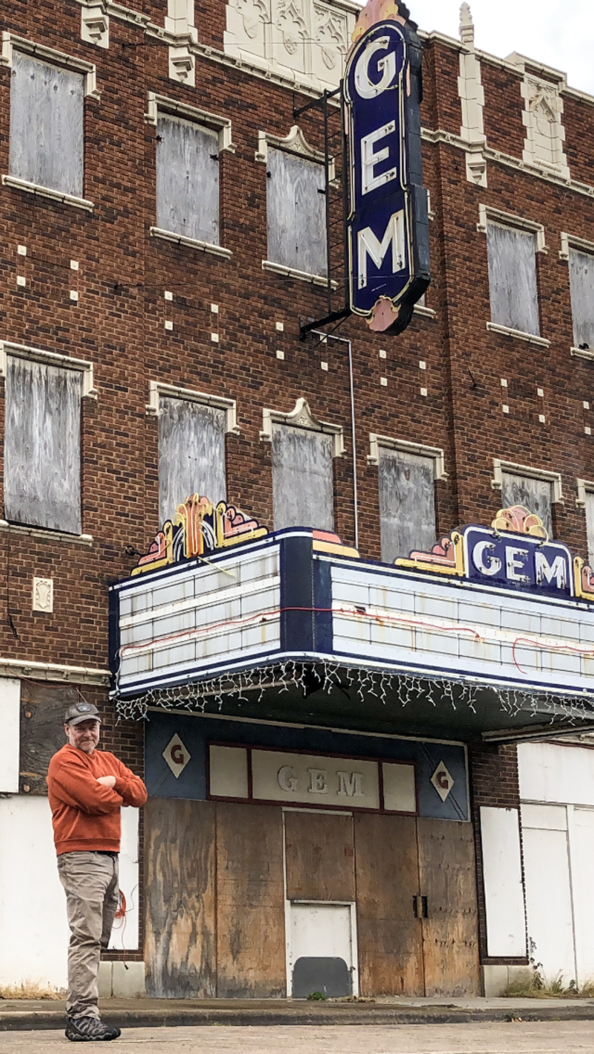 Portrait of photographer Keith Dotson on 7th Street in front of the abandoned Gem Theatre in Cairo Illinois.