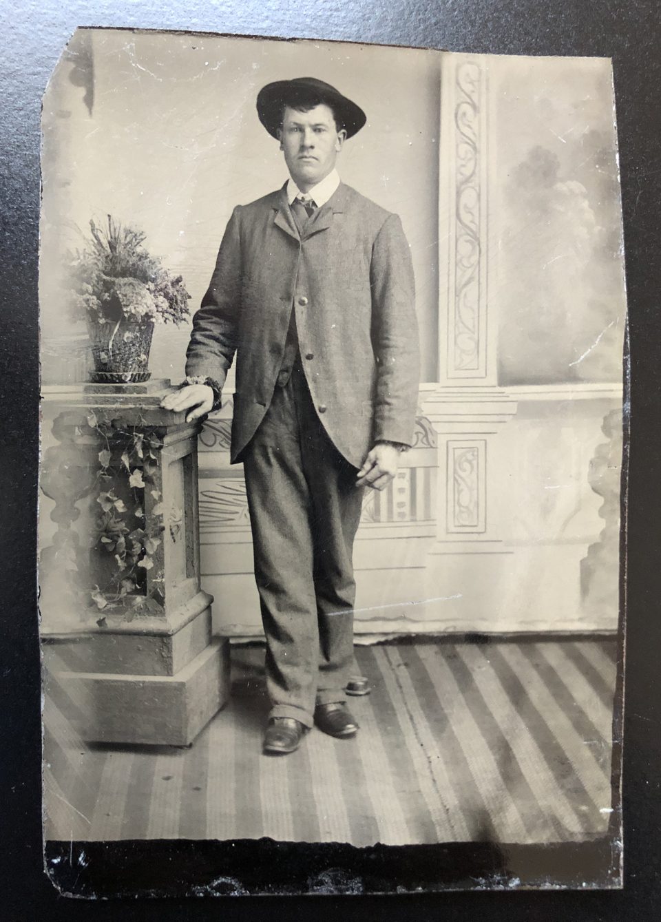 Full length tintype portrait of a man in suit and hat, possibly late 1870s. Photographer unknown.