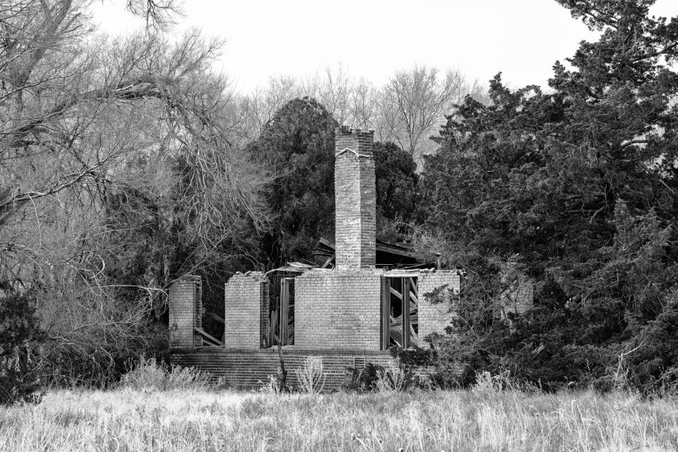 Black and white photograph of the abandoned 1930s school in Hext, Oklahoma. Photo copyright Keith Dotson.