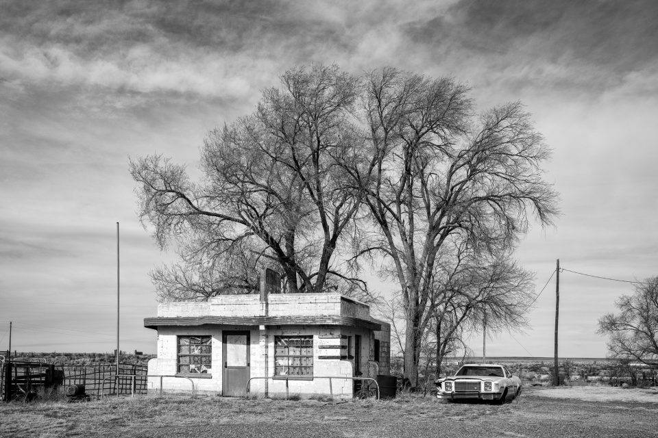 Black and white photograph of the Brownlee Diner in Glenrio, Texas. The Art Moderne style diner was built in 1952 to serve travelers on old Route 66. It closed in the early 1960s and operated as a curio shop for a while.