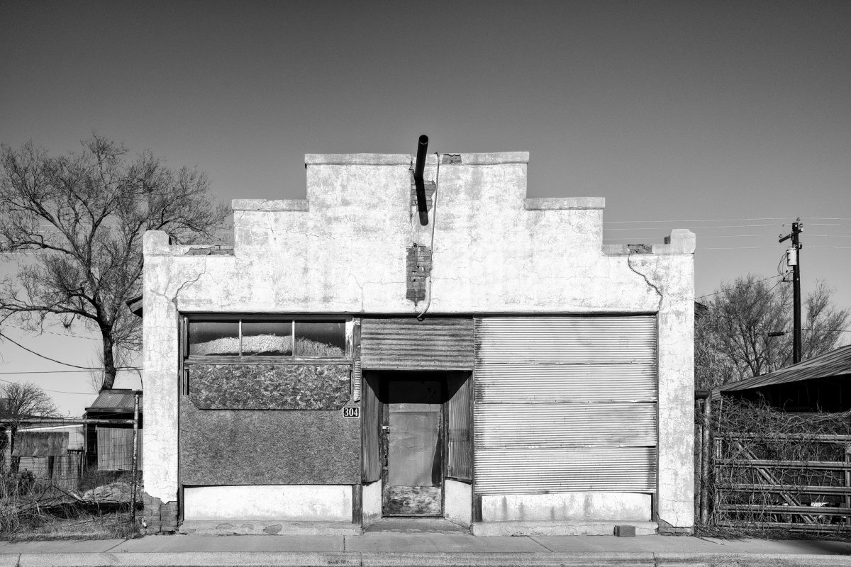 Black and White Photograph of an Abandoned Building in Carrizozo, New Mexico with a UFO in Sky. Buy a Fine Art Print.