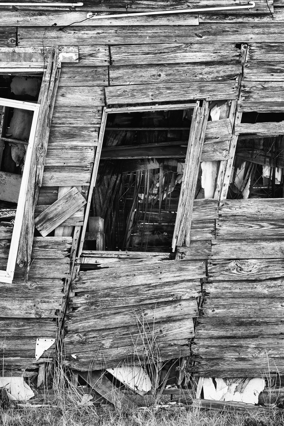 Detail view of the leaning shack in Texola, Oklahoma. Black and white photograph by Keith Dotson.