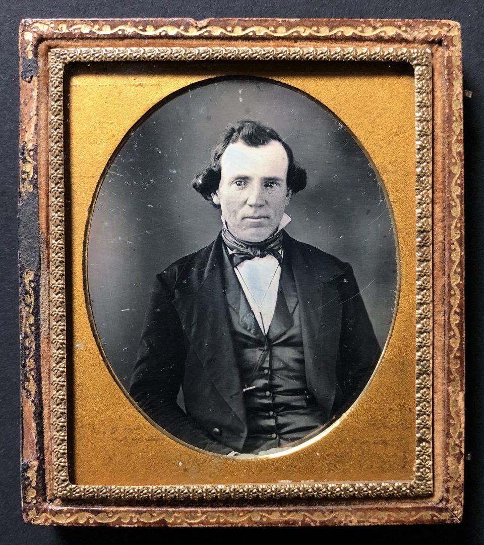 Daguerreotype portrait of a man in a silky vest, circa the 1840s. Photographer, location, and subject are all unknown.