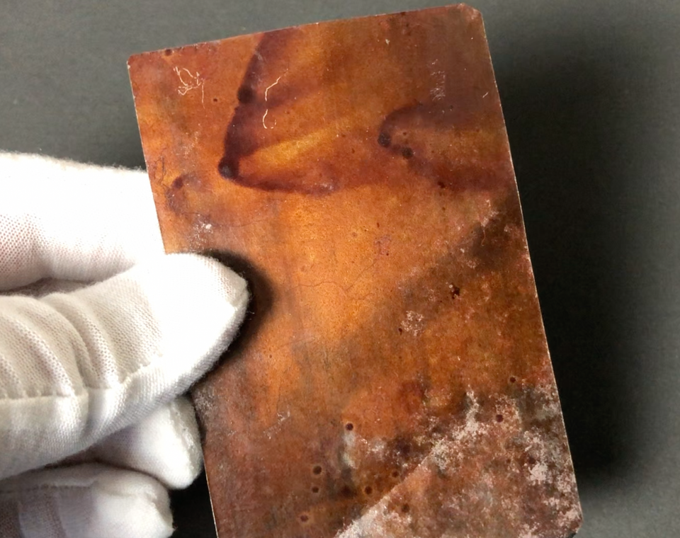 On the reverse side of the 1870s tintype, we can see the dried coatings of varnish.
