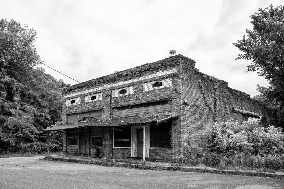 Abandoned Historic Storefront in a Small Town, Black and White Photograph by Keith Dotson. Click here to buy a fine art print.