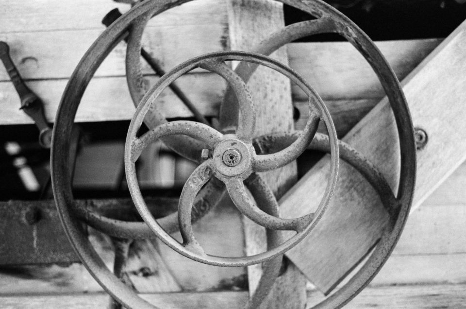 Detail photograph of pulley wheels on an antique farm machine by Keith Dotson. Shot on Kodak Tri-X black and white film using a 40-year-old Pentax K1000 camera and 50mm lens.
