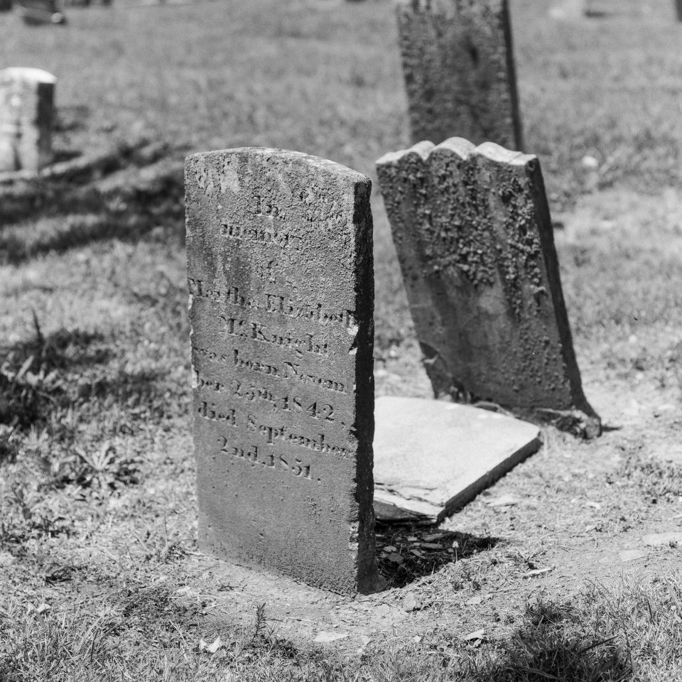 Headstone circa 1851. Black and white photograph by Keith Dotson, shot with Hasselblad 500 C/M, with Cinestill Double X BwXX film.