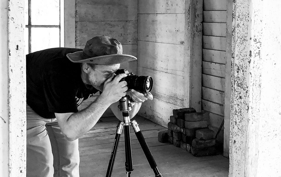 Portrait of fine art photographer Keith Dotson on location in an abandoned farm house.