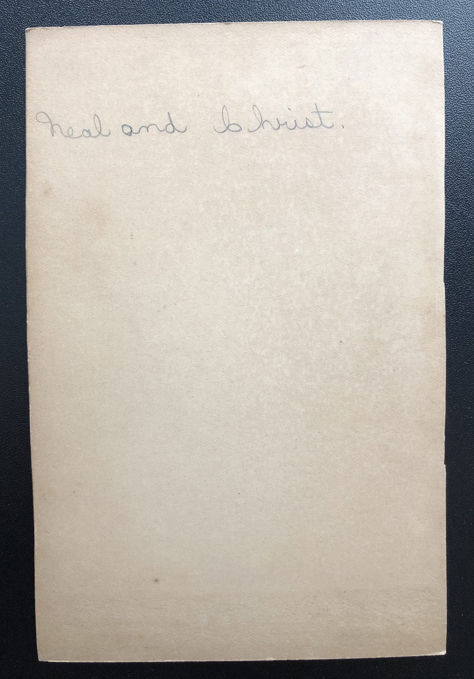 The back of the cabinet card photograph shows the handwritten names "Neal and Christ."