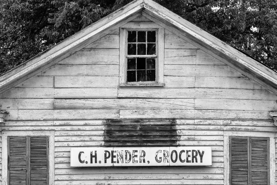 Black and white photograph of the sign on the front of the 1880s C.H. Pender store by Keith Dotson.