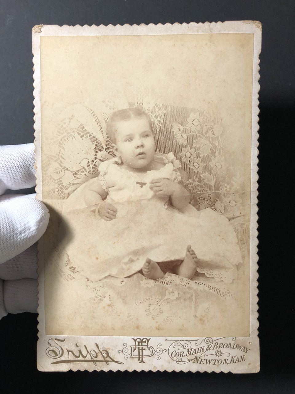 This toddler did a great job holding still for the lens of F.D. Tripp in Newton, Kansas in the 1880s or 1890s. The print style includes a heavy white vignette.