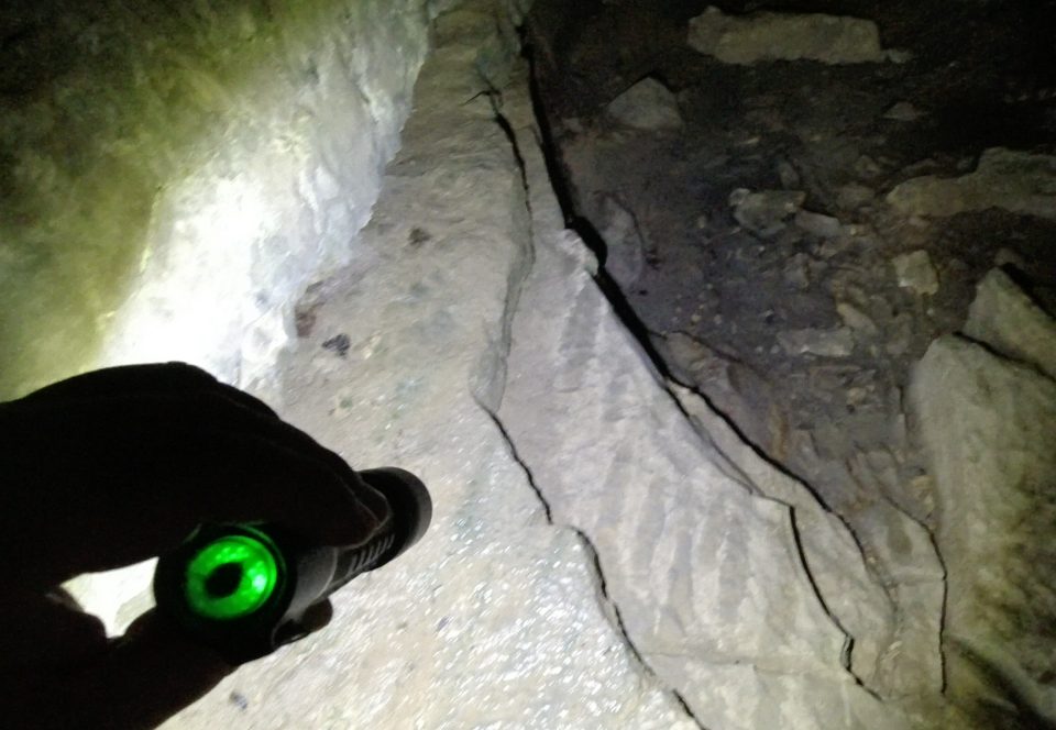 A screenshot of the Coast XP11R in action inside the cave. The green light on the back tells you that you have a good battery level.
