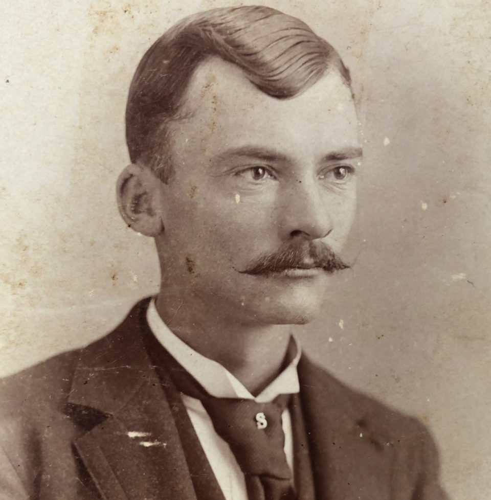 A close-up look at the capital S tie pin on this gentleman photographed by C.R. Von der Heiden in Newton, Kansas.