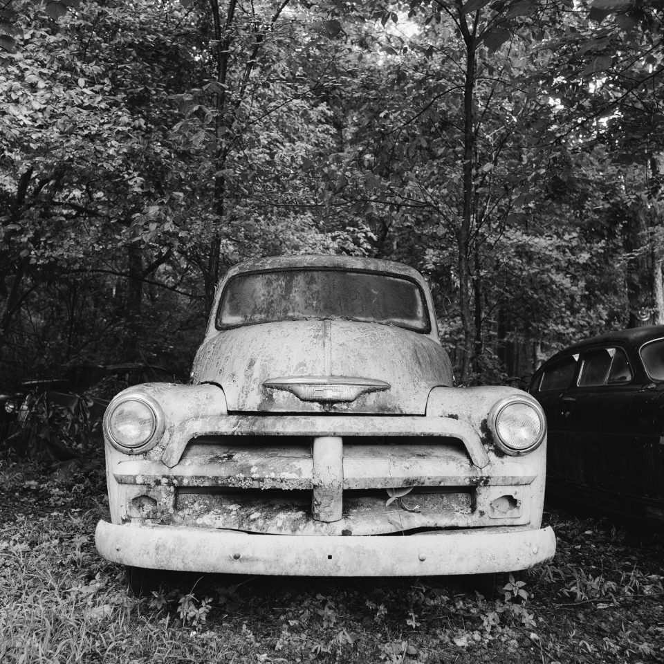 The Ghost - Pale Antique Truck in a Dark Forest - Black and White Photograph (Square Format) by Keith Dotson. Buy a fine art print.