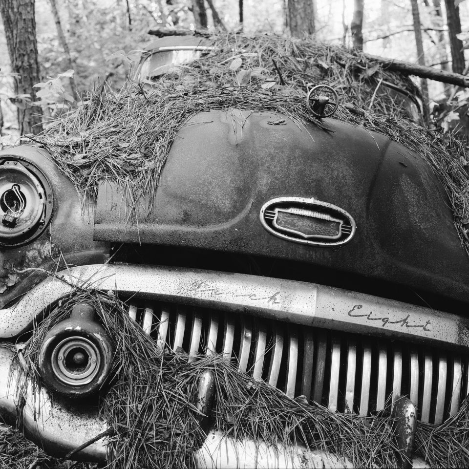 Junked Buick Super Eight Circa 1951 - Black and White Photograph by Keith Dotson. Square format. Buy a fine art print.