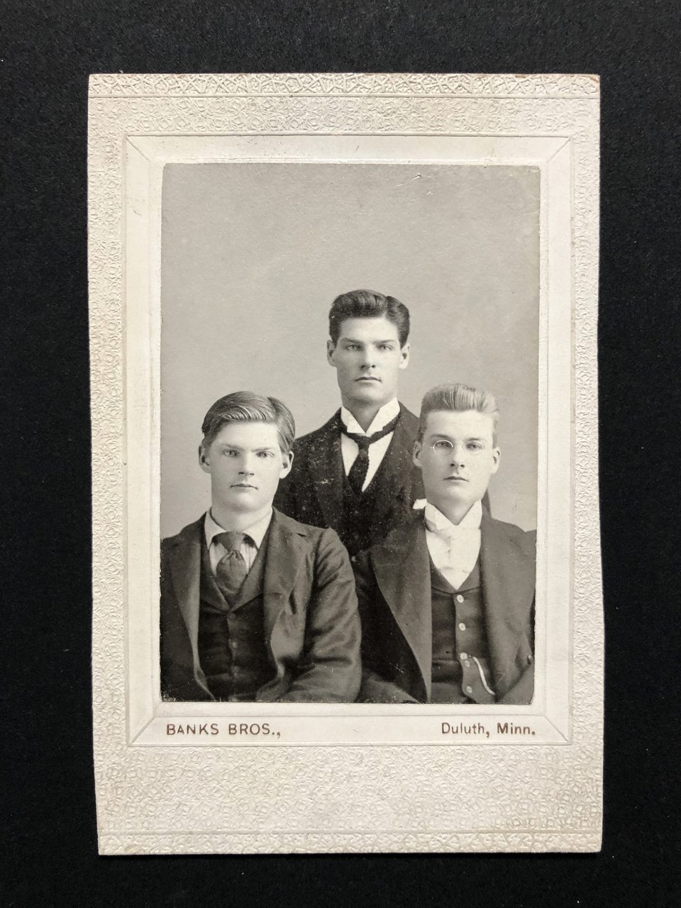 This gelatin silver Banks Brothers portrait of three young men is larger than a carte de visite and smaller than a cabinet card.