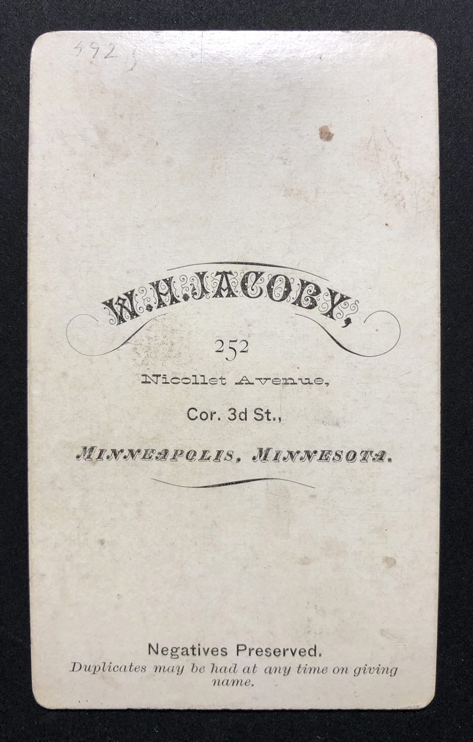 The mark of photographer W.H. Jacoby on the back of a carte de visite portrait.