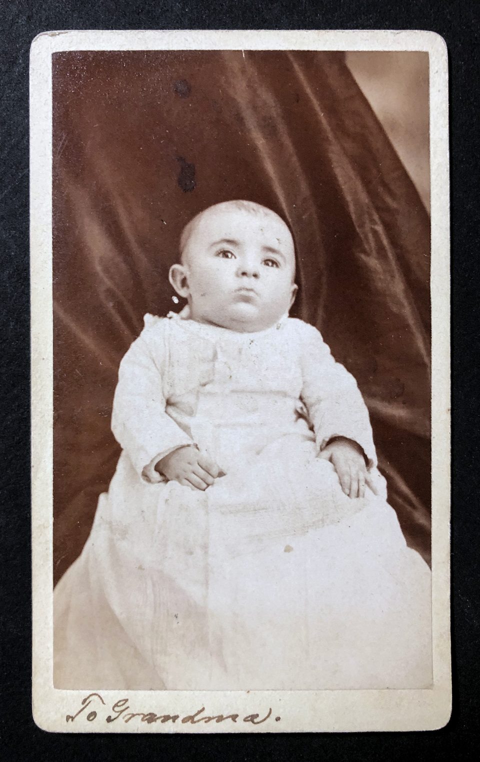 Carte de visite size portrait by John H. Oleson of an infant, inscribed on the bottom edge in pen and ink, "To Grandma." This must have been very special to that grandmother.