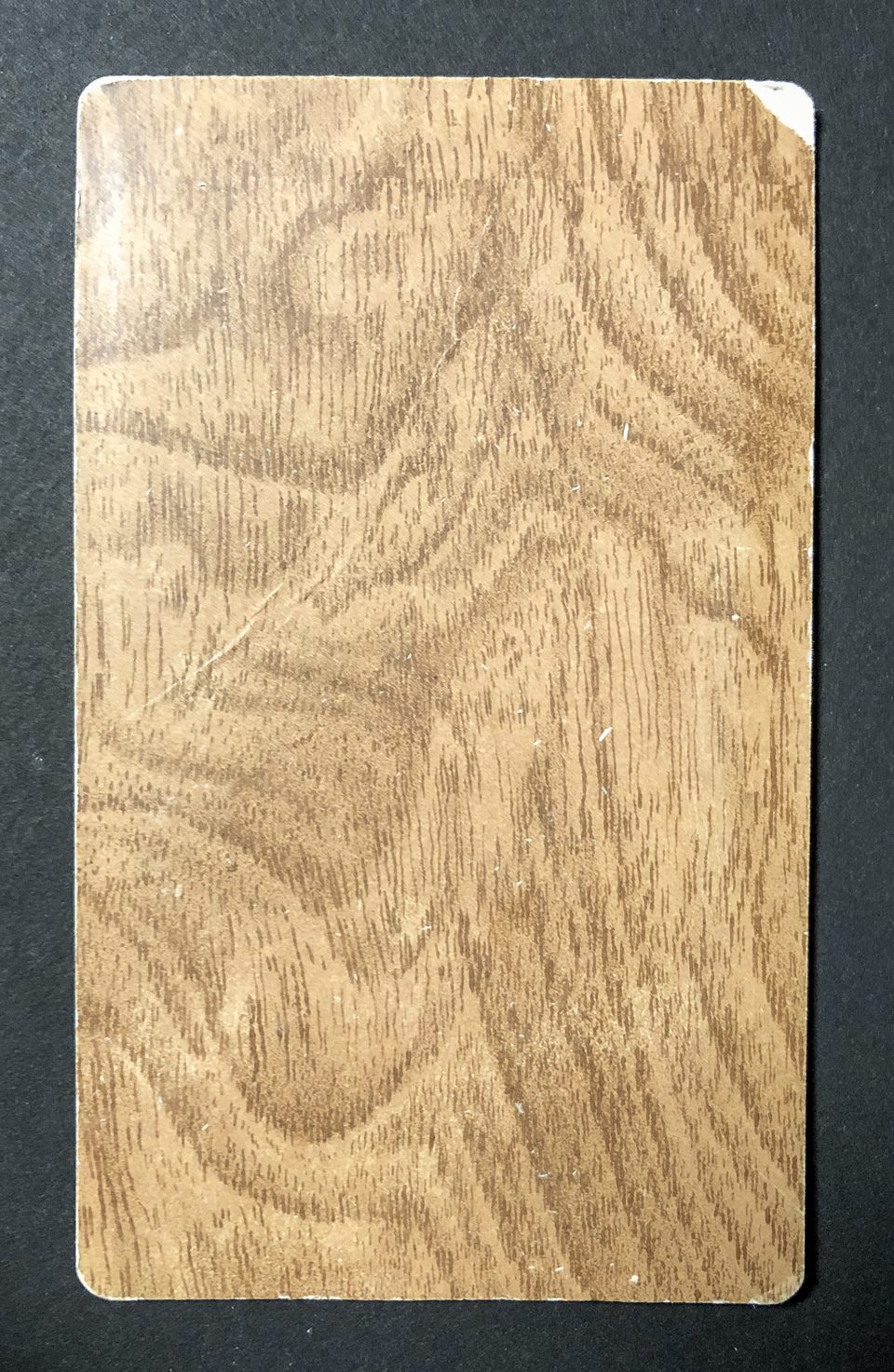 The reverse of the card is covered by a printed woodgrain texture. It's the only time I've ever seen this!