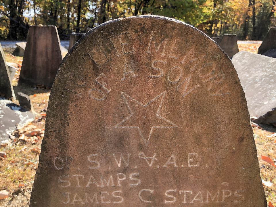 This tombstone located in the Stamps Cemetery shows one example of the inverted stars that have been viewed as symbols of witchcraft. The other strange symbol beneath it is simply an unusual rendering of an ampersand.
