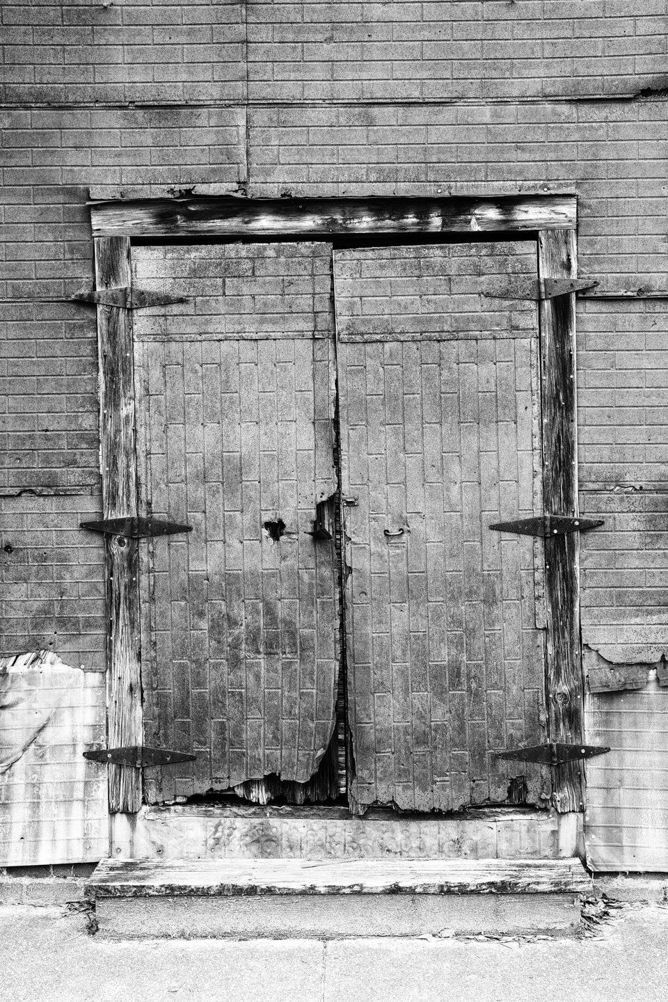Front Doors of a Rusty Cotton Warehouse in Newbern, Alabama - Black and White Photograph by Keith Dotson.