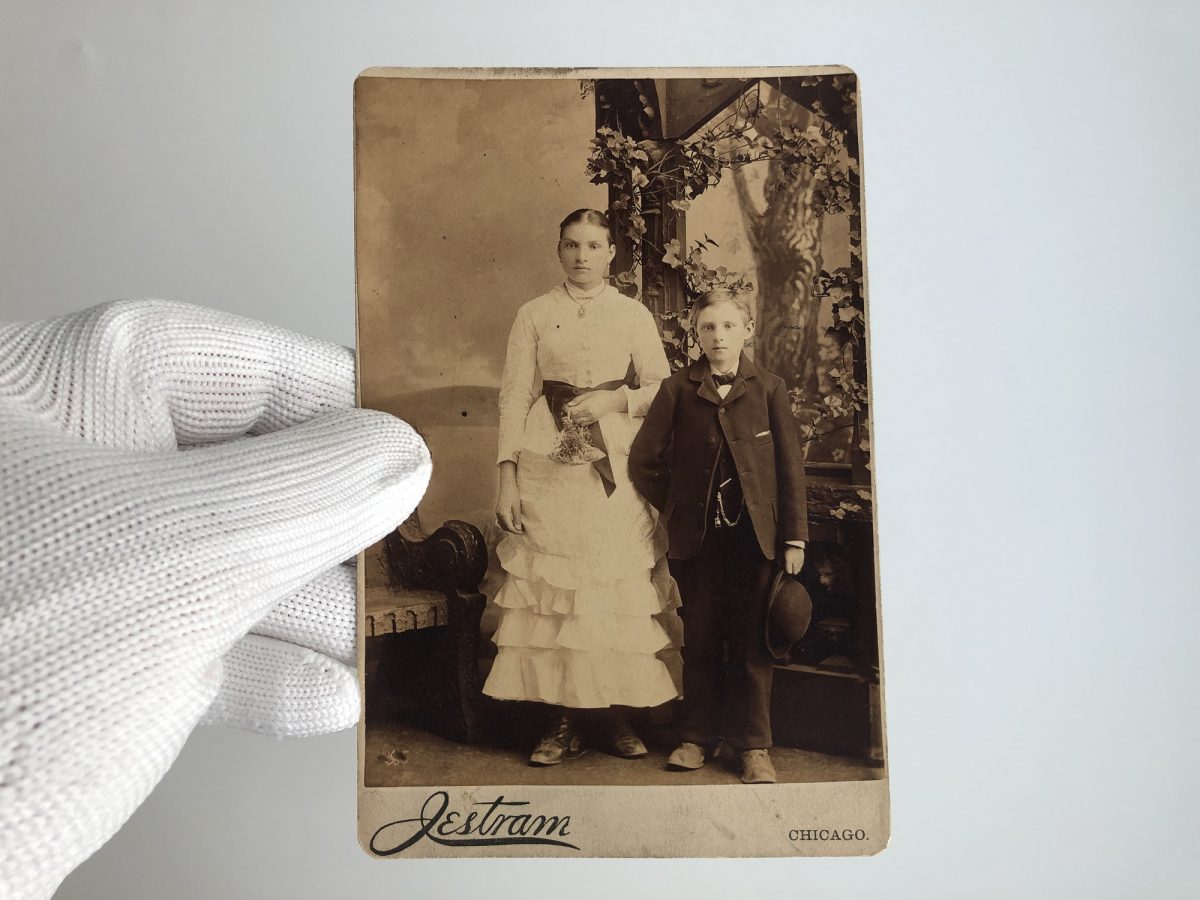 Cabinet card portrait of young siblings shot in the Chicago studio of Henry Jestram in 1884