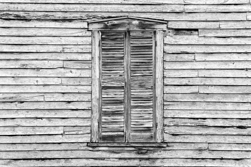 Shuttered window on the side of the 1875 Hamilton-Lay General Store. Black and white photograph by Keith Dotson. Buy a fine art print.