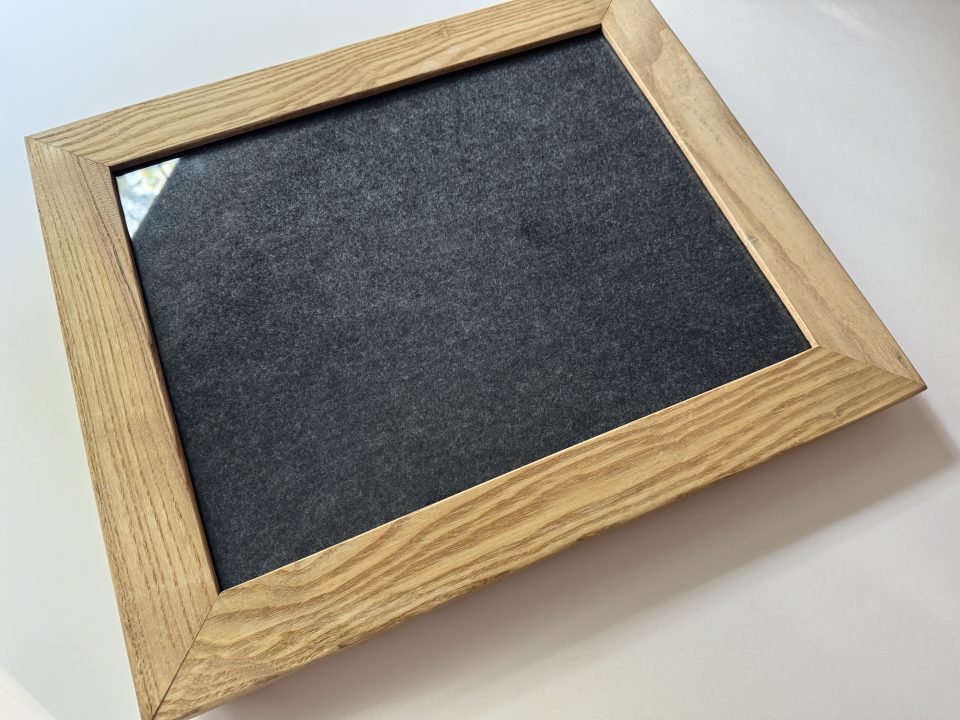 Contact Printing frames are specifically made for contact printing. They hold the negative tight against the paper and the folding back (shown below) allows you to check the exposure of the print without shifting the negative out of place.