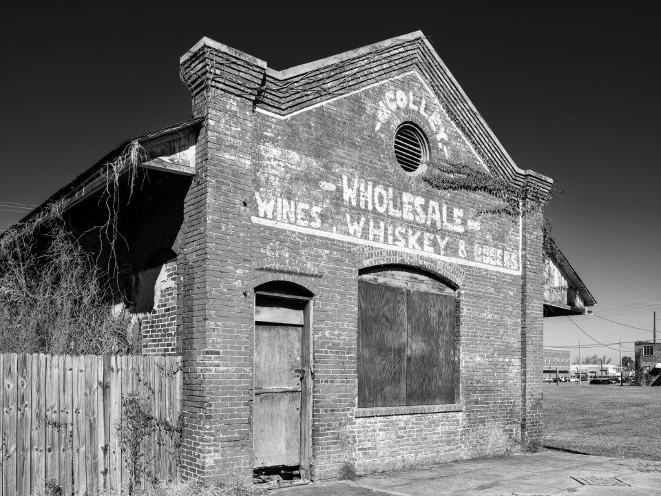 Black and white photograph by Keith Dotson of the Trolley Line Freight Depot, built in 1905 for the old Birmingham to Bessemer trolley service. After the trolley stopped using it, it became a soft drink warehouse and later a warehouse for Colley's Wholesale Liquors.
