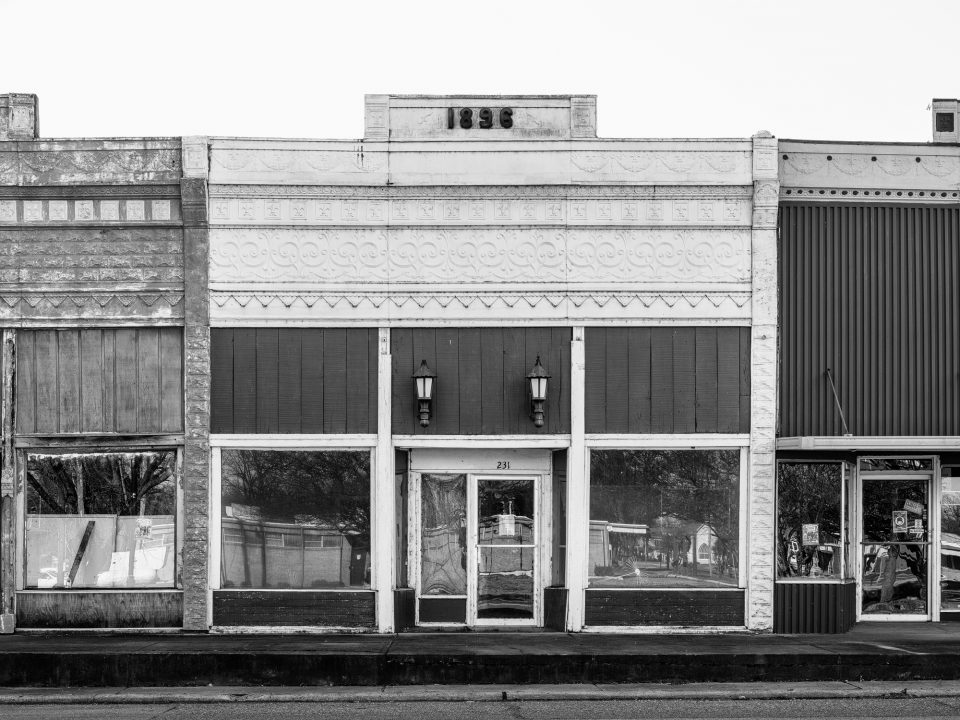The central structure of the Black building trio, dated 1896, features a decorative stamped metal storefront. Black and white photograph by Keith Dotson. Prints are available.
