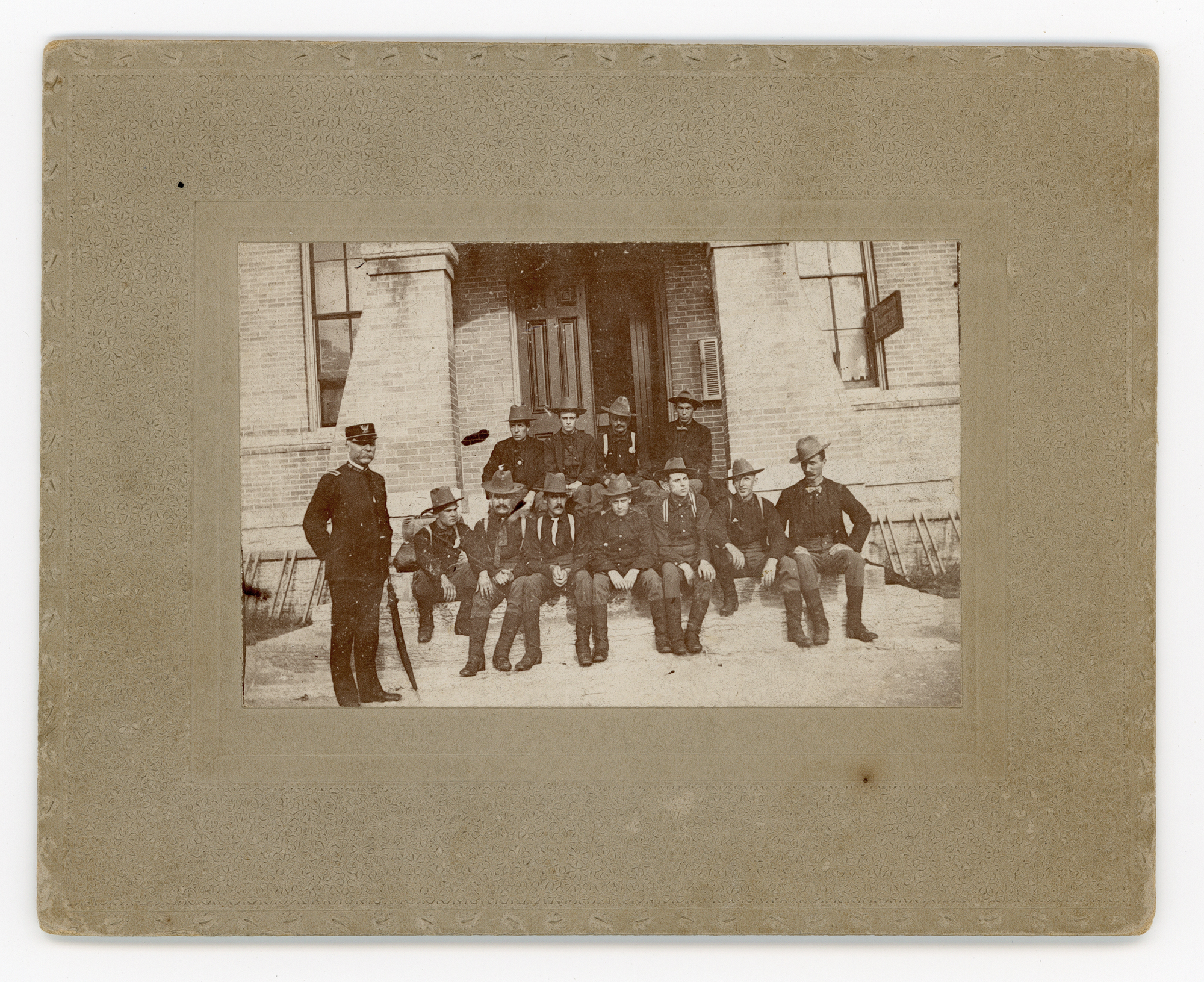Group photograph of men in very similar attire, sitting on the steps of a Western Union telegraph office. The photograph is not dated and offers no clues as to the people or reason.