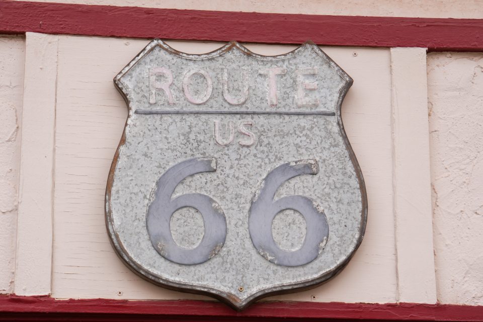 A weathered Route 66 shield seen in Winslow, Arizona. Photo by Teena Young.