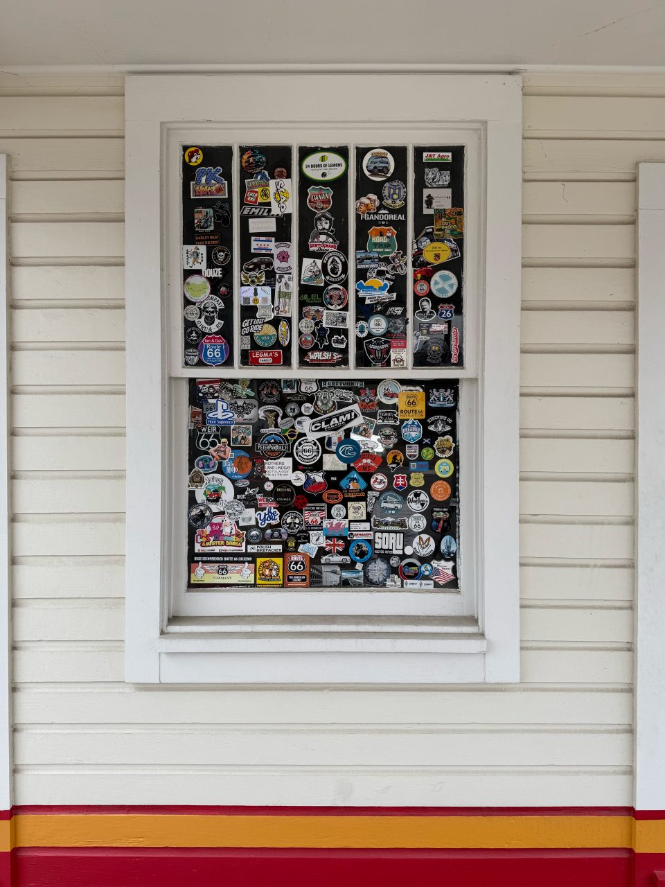 Stickers left by visitors from around the world on the window at Soulsby's Service Station in Mount Olive, Illinois.