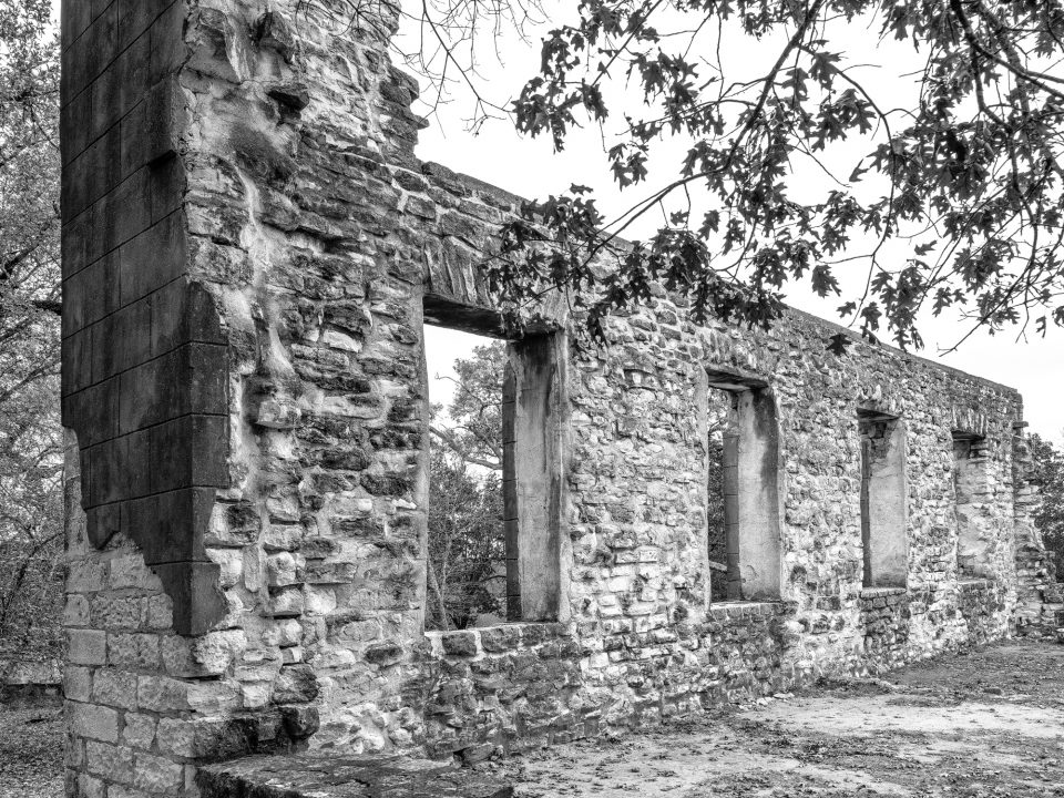 Black and white photograph of a row of large windows in the ruins of Salado College in Salado, Texas. Photograph by Keith Dotson.