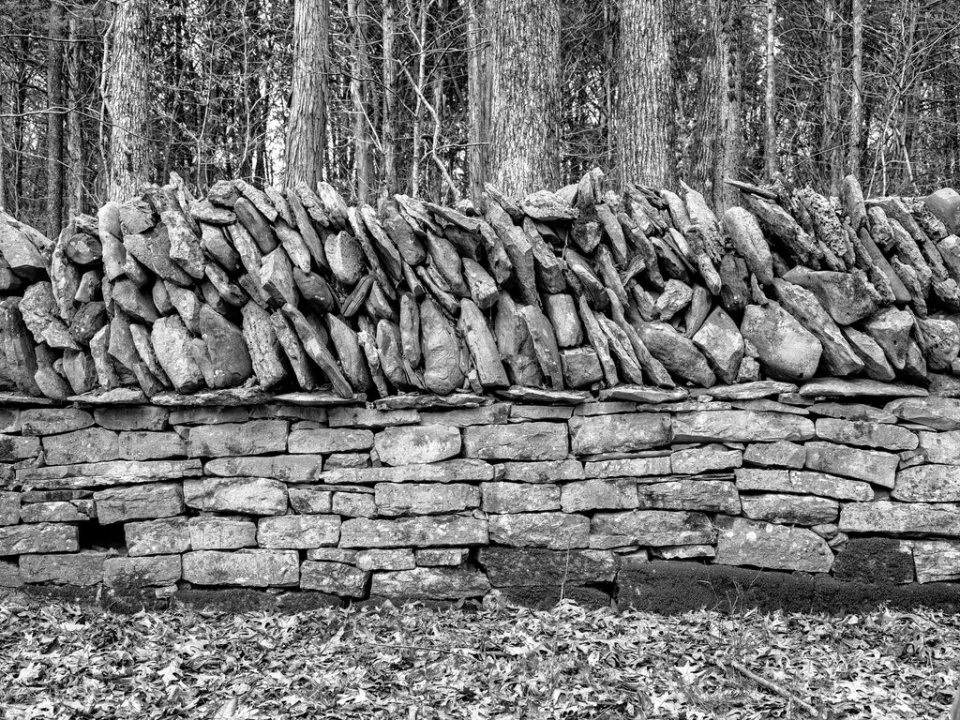  Old stone wall in Tennessee. Black and white photograph by Keith Dotson. Buy a fine art print here.