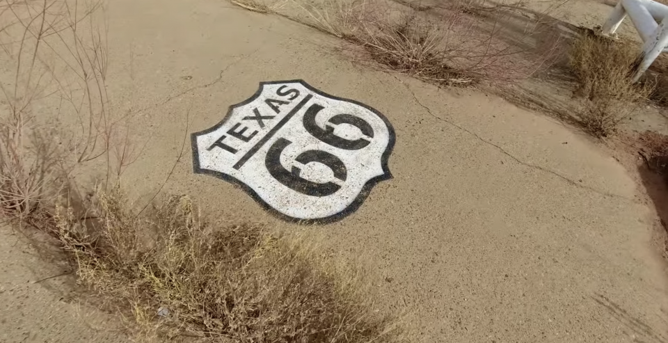 A Route 66 shield painted near the former location of the fuel pumps.