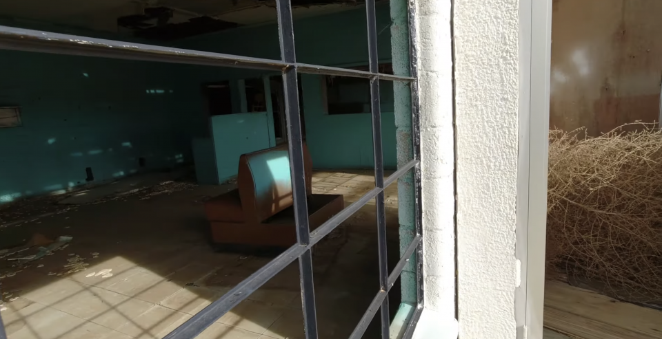 A peek inside the building that once housed the gas station and cafe of the Texas Longhorn Motel in Glenrio.