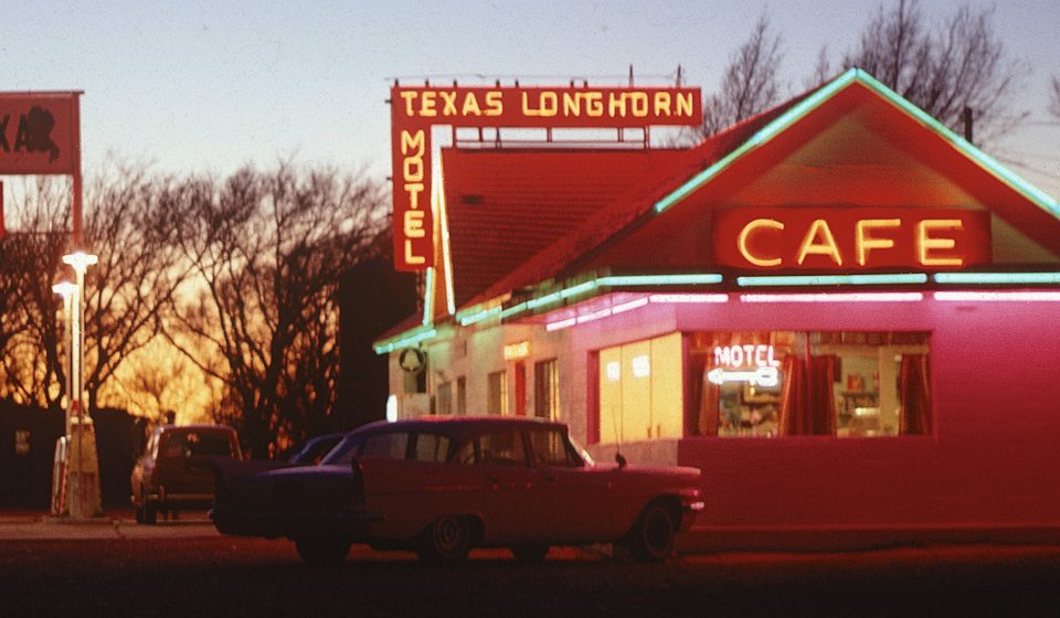In this close-up we can see the cool late-'60s cars parked at the Cafe, which is well lit and looks quite inviting. A Bell Telephone sign in front reminds us of the importance of public phones in the days before cell phones. Glenrio was an isolated location then as it remains today.