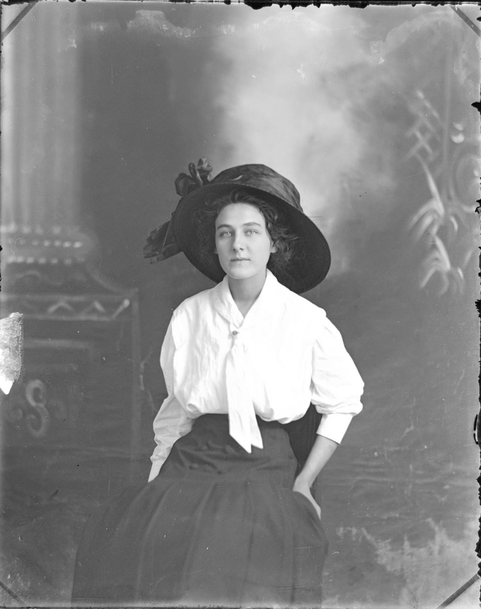 Portrait of a young woman in a picture hat, probably photographed between 1908 and 1912.