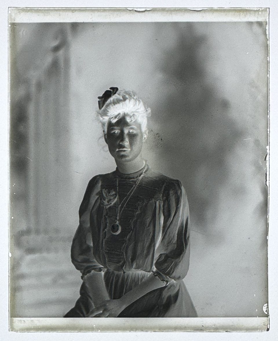 This unidentified young woman wears a locket or possible a pocket watch on a chain around her neck.