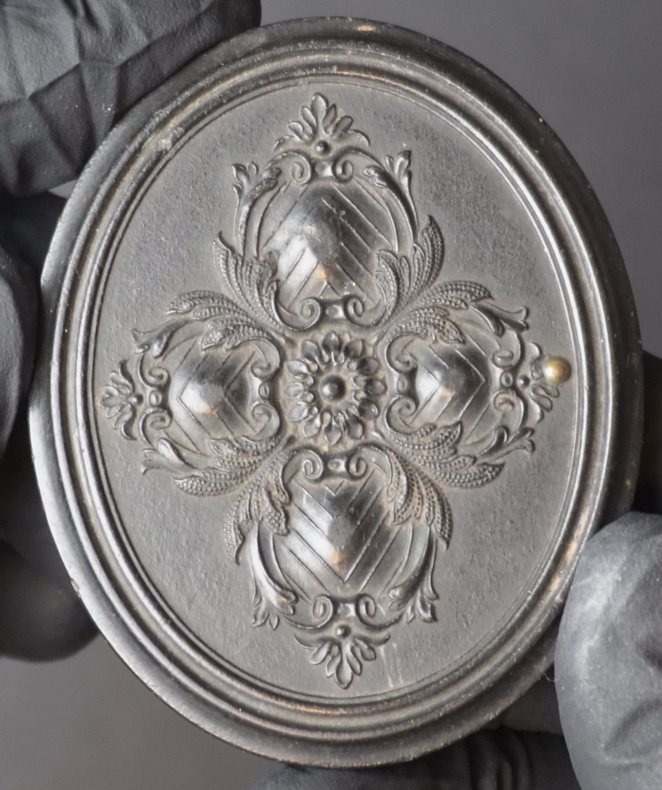 Rather than actual Indonesian gutta-percha, these early thermoplastic "gutta-percha" cases (also known as union cases) were made of a mixture (or union) of shellac, saw dust, and lamp black for coloring. Today, a well-preserved case is often more valuable than the photograph it contains.